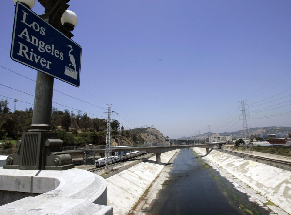 FILE - A shallow Los Angeles River is seen on June 29, 2007. The river wanders through 14 cities from the San Fernando Valley through downtown Los Angeles and south to Long Beach, where it empties into the ocean. On Monday, Feb. 5, 2024, fed by a slow-moving atmospheric river dumping historic amounts of rain, the river was raging and even threatened to overspill its flood-control barriers in some sections. (AP Photo/Nick Ut, File)