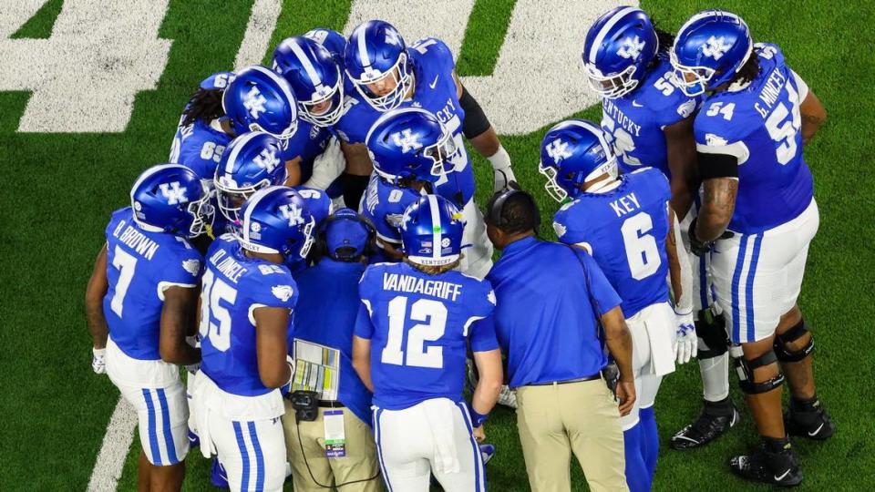 New Kentucky quarterback Brock Vandagriff (12) huddles the Wildcats before their first series together Saturday night. Vandagriff threw three touchdown passes during UK’s 31-0 victory over Southern Mississippi.