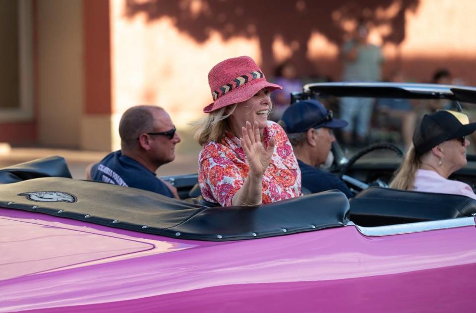 Candy Clark, star of George Lucas’ film “American Graffiti”, waves to spectators during the 2022 classic car parade in Modesto.