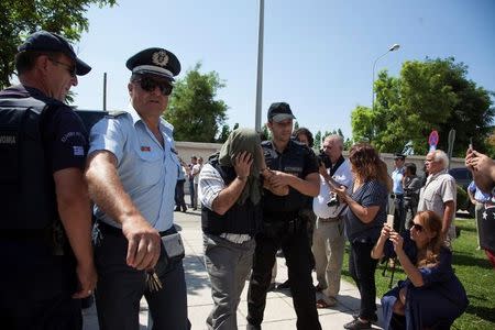 One of the eight Turkish soldiers who fled to Greece in a helicopter and requested political asylum after a failed military coup against the government, is escorted to the courthouse of the northern city of Alexandroupolis, Greece, July 21, 2016. REUTERS/Antonis Pasvantis