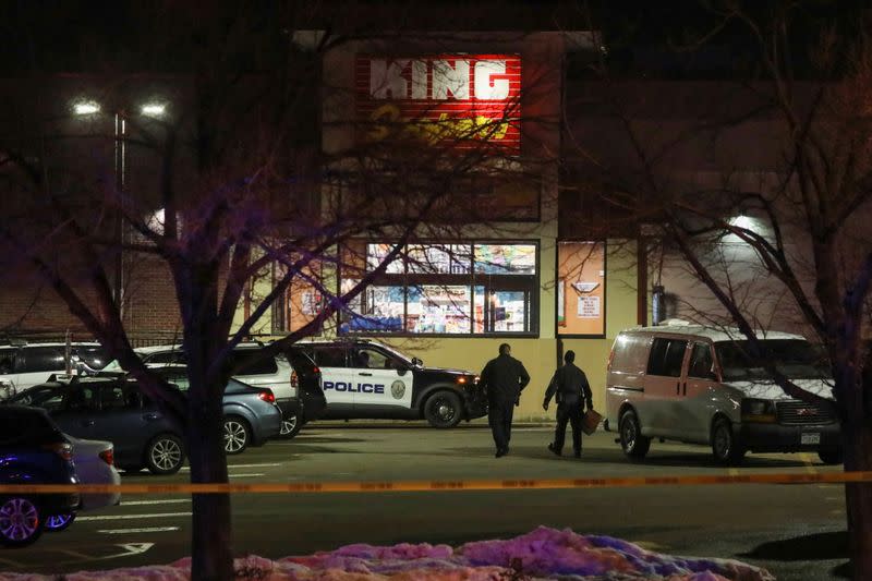 Law enforcement officers investigate the site of a shooting at a King Soopers grocery store in Boulder