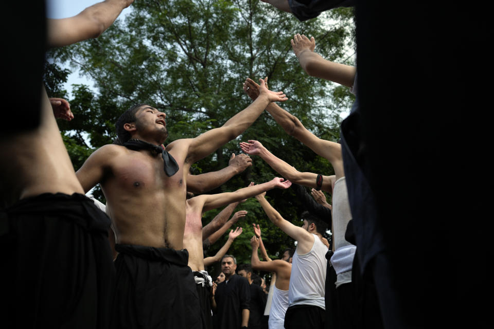 Shiite Muslims beat their chests during a procession to mark Ashoura, in Islamabad, Pakistan, Friday, July 28, 2023. Ashoura is the Shiite Muslim commemoration marking the death of Hussein, the grandson of the Prophet Muhammad, at the Battle of Karbala in present-day Iraq in the 7th century. (AP Photo/Rahmat Gul)