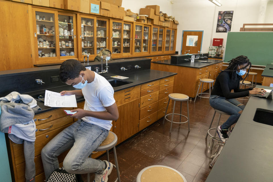 Junior and senior students use smart phones and tablets to do their work in a chemistry class during the coronavirus outbreak at Roosevelt High School - Early College Studies, Thursday, Oct. 15, 2020, in Yonkers, N.Y. (AP Photo/Mary Altaffer)