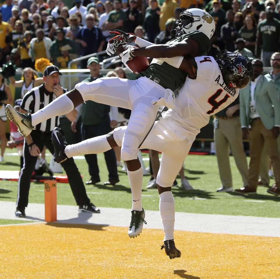 FILE - In this Nov. 3, 2018, file photo, Baylor's wide receiver Denzel Mims, left, pulls down the game winning touchdown over Oklahoma State's cornerback A.J. Green, right, in the second half of an NCAA college football game in Waco, Texas. Mims is a possible pick in the NFL Draft which runs Thursday, April 23, 2020 thru Saturday, April 25. (Michael Bancale/Waco Tribune-Herald via AP, File)