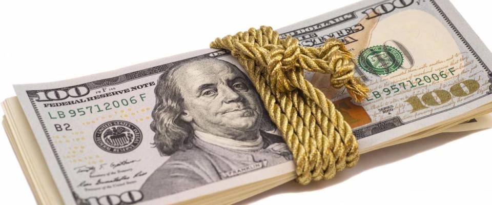 hundred dollar banknotes with golden rope band, isolated on white background