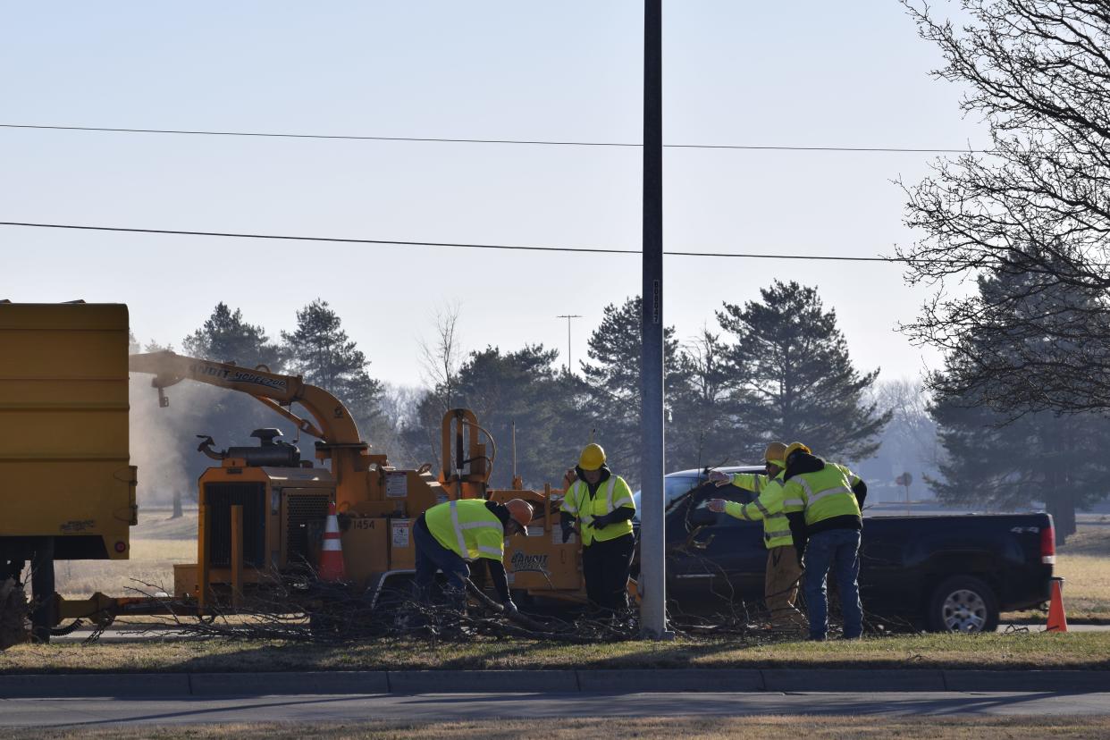 City of Salina crews work and clean up a tree that came down in a median on South Ninth Street after an extreme wind event in December 2021.