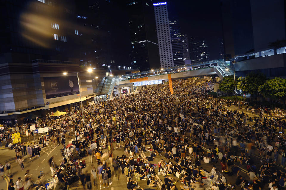 Pro-democracy protesters gather in the early hours of the morning, while others spent the night on the streets around the government headquarters, Tuesday, Sept. 30, 2014 in Hong Kong.  (AP Photo/Wong Maye-E)