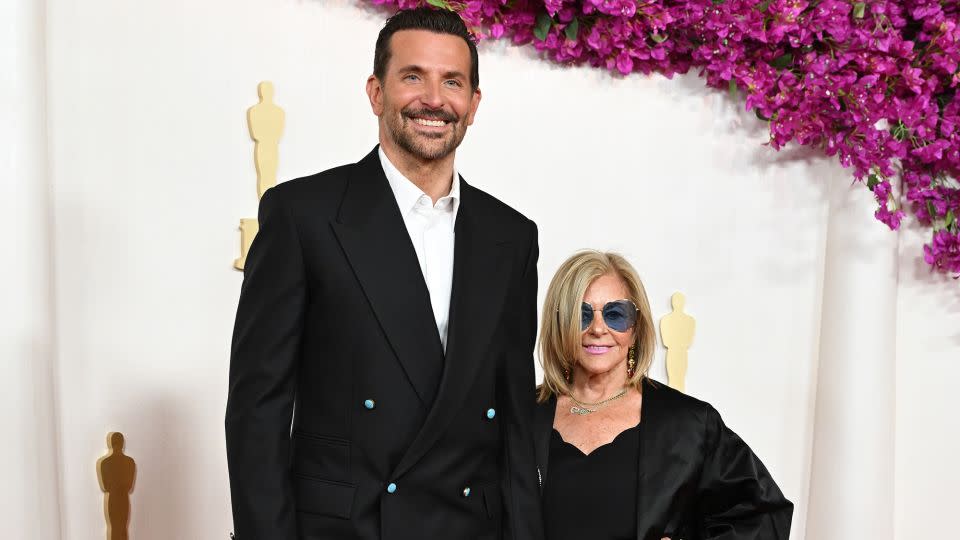 Best Actor nominee Bradley Cooper kept it classic with a custom Louis Vuitton suit and Tambour watch. Cooper arrived alongside his mother, Gloria Campano. - Gilbert Flores/Variety/Getty Images