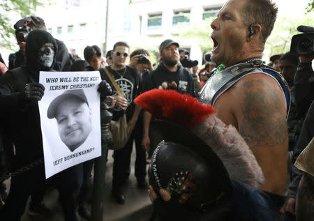 A conservative protester (R) yells at a group of anti-fascist during competing demonstrations in Portland, Oregon, U.S. June 4, 2017. REUTERS/Jim Urquhart