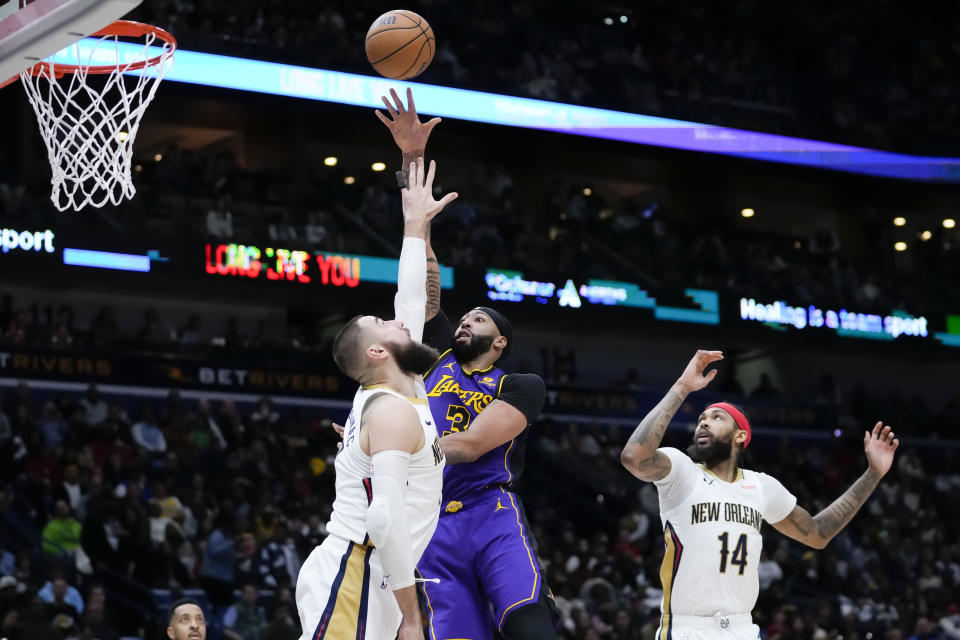 Los Angeles Lakers forward Anthony Davis (3) shoots against New Orleans Pelicans center Jonas Valanciunas (17) in the second half of an NBA basketball game in New Orleans, Sunday, Dec. 31, 2023. The Pelicans won 129-109. (AP Photo/Gerald Herbert)