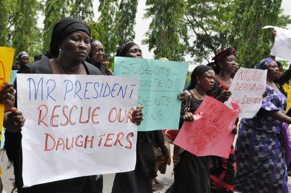 Unidentified mothers call for the president to help, during a demonstration with others who have daughters among the kidnapped school girls of government secondary school Chibok, Tuesday April 29, 2014, in Abuja, Nigeria. Two weeks after Islamic extremists stormed a remote boarding school in northeast Nigeria, more than 200 girls and young women remain missing despite a “hot pursuit” by security forces and desperate parents heading into a dangerous forest in search of their daughters. Some dozens have managed to escape their captors, jumping from the back of an open truck or escaping into the bush from a forest hideout, although the exact number of escapees is unclear. (AP Photo/ Gbemiga Olamikan)