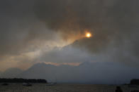 <p>Smoke from a wildfire shrouds mountain peaks as seen from Leek’s Marina on the shore of Jackson Lake, in Grand Teton National Park, Wyo., Aug 24, 2016. (AP Photo/Brennan Linsley) </p>