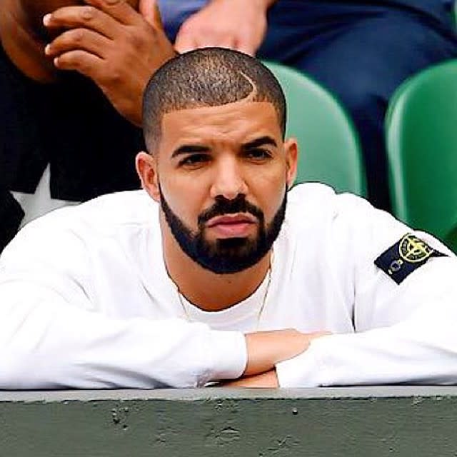 "Just like family," huh? Although Serena Williams said last month that her and rapper Drake are longtime "friends," and "just like family," when asked about his constant presence during her Wimbledon matches, the pair appeared to be much more than that when they were pictured cuddling at Sotto restaurant in Cincinnati on Sunday night. The 28-year-old rapper and the 33-year-old tennis champ were reportedly "making out" in a private room in the back of the restaurant, TMZ reports, and weren't shy about showing some PDA in front of six other guests at their table. However, it's hard to tell if there's really any kissing happening in the photos, but Serena does appear to be sitting on the "Back To Back" rapper's lap while the two get handsy. <strong>PHOTOS: Serena Williams Flaunts Her Curves for 'NY Magazine' After Being Body Shamed Following Her Wimbledon Win</strong> Drake was in the stands on Sunday in Cincinnati, when Serena defended her title at the Western & Southern Open. He's made no secret that he's a huge fan of the athlete, Instagramming this shot of him intensely watching one of her Wimbledon matches last month. He was also, obviously, a very animated spectator. Getty Images The two have actually been the subject of romance rumors for years now, and last July, Serena's ex-boyfriend, rapper Common, admitted that his past beef with the Canadian rapper was in fact over the tennis champion. "For me, I think it was an emotional thing," he told VladTV. "Meaning, I was feeling like, at that time, I think it was the Drake-Serena situation -- I ain't know what was going on with that. And I ain't know if he was throwing things, shots at me. You know, this my ex, and we kinda, you know, going our separate ways. Unfortunately, the war might have been over a girl, even though at the time I never said that." In March, Serena opened up to <em>Vogue</em> about her dating life -- or rather, her lack of one. "I am really shy. I don't talk to guys," Serena surprisingly said. "Friends? Yes. But a potential? No. I get nervous that I will say the wrong thing, and then I just start laughing." Still, she made it clear that she's far from desperate. "I guess," she said, when asked about her desire to start a family and have children. "I'm not even looking for it." <strong>NEWS: Serena Williams Makes a Grand Slam Against 'Racist and Sexist' Remarks</strong> Check out the video below to see <em>Harry Potter</em> author J.K. Rowling slam a Serena body shamer in the best way possible.