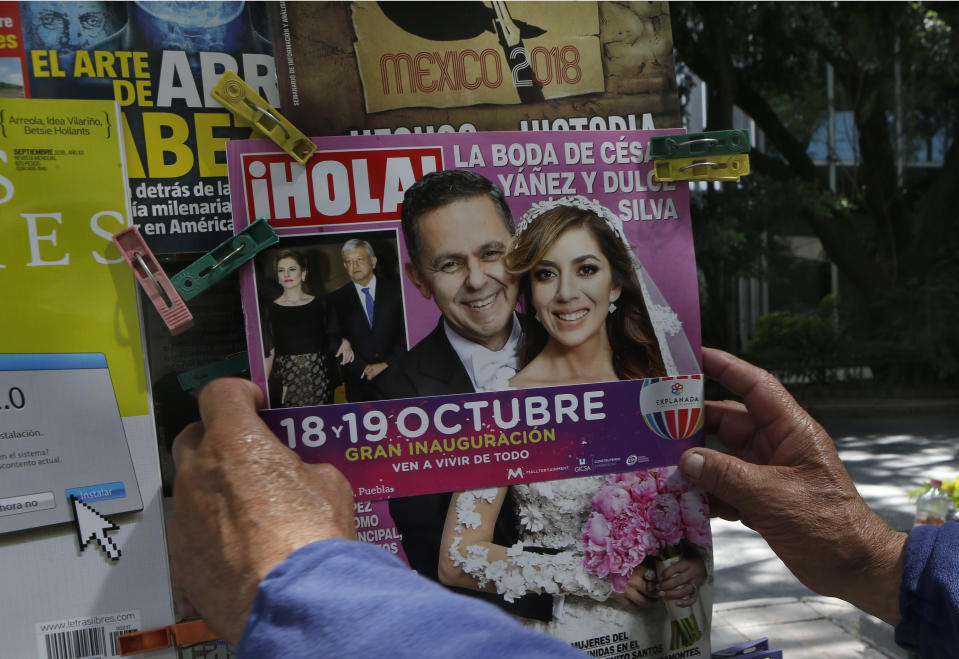 The cover of Hola! magazine features Cesar Yanez, a personal adviser to Mexican President-elect Andres Manuel Lopez Obrador, and his bride Dulce Maria Silva in Mexico City, Thursday, Oct. 4, 2018. The wedding, officiated by an archbishop, with designer dresses, palatial decorations and a huge convention-center reception, was likely the last image Mexico’s austerity-minded president-elect wanted one of his closest advisers projecting, and it quickly drew criticism. (AP Photo/Marco Ugarte)