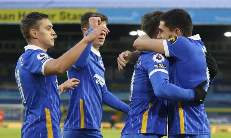 Brighton teammates hug Neal Maupay in celebration