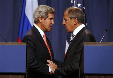 U.S. Secretary of State John Kerry (L) and Russian Foreign Minister Sergei Lavrov (R) shake hands after making statements following meetings regarding Syria, at a news conference in Geneva September 14, 2013. REUTERS/Larry Downing