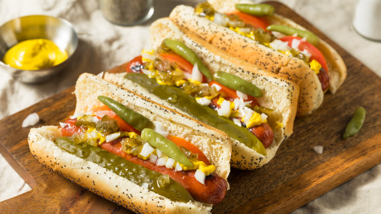 Chicago-style hot dogs on a cutting board