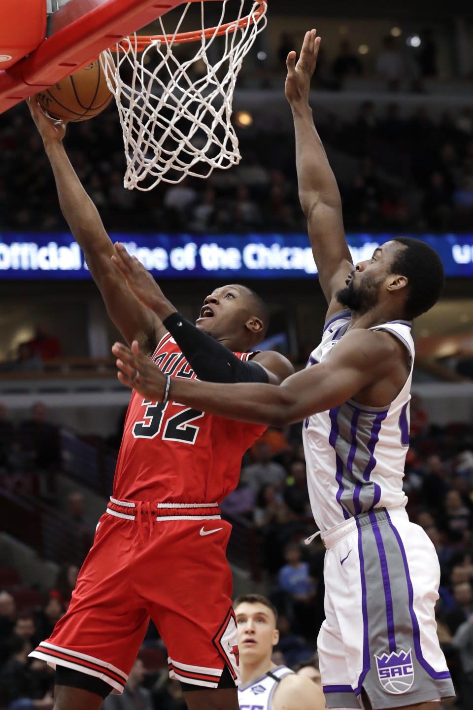 Chicago Bulls guard Kris Dunn, left, shoots against Sacramento Kings forward Harrison Barnes during the second half of an NBA basketball game in Chicago, Friday, Jan. 24, 2020. (AP Photo/Nam Y. Huh)