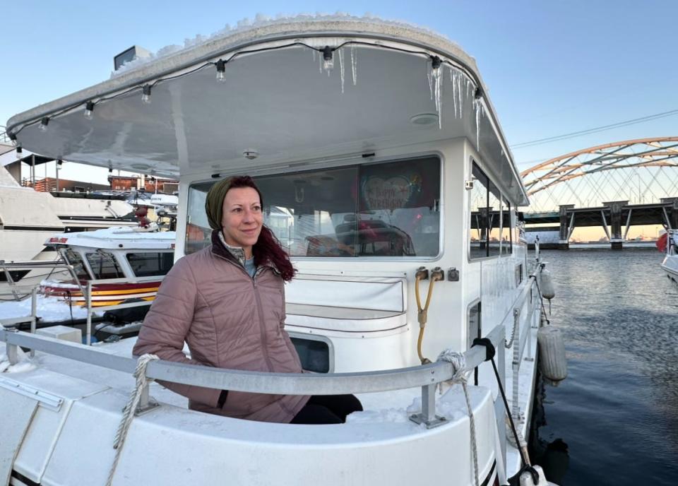 Stacy Rae Seminick aboard her houseboat, dripping with icicles after the last snowstorm.