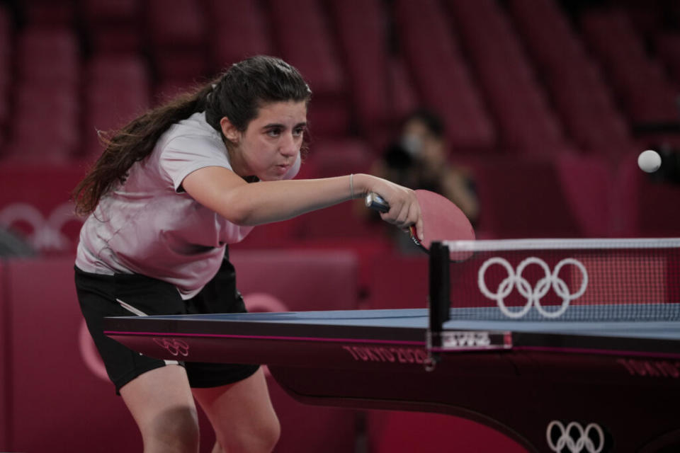 Syria’s Hend Zaza competes during women’s table tennis singles preliminary round match against Austria’s Liu Jia at the 2020 Summer Olympics, Saturday, July 24, 2021, in Tokyo. (AP Photo/Kin Cheung)