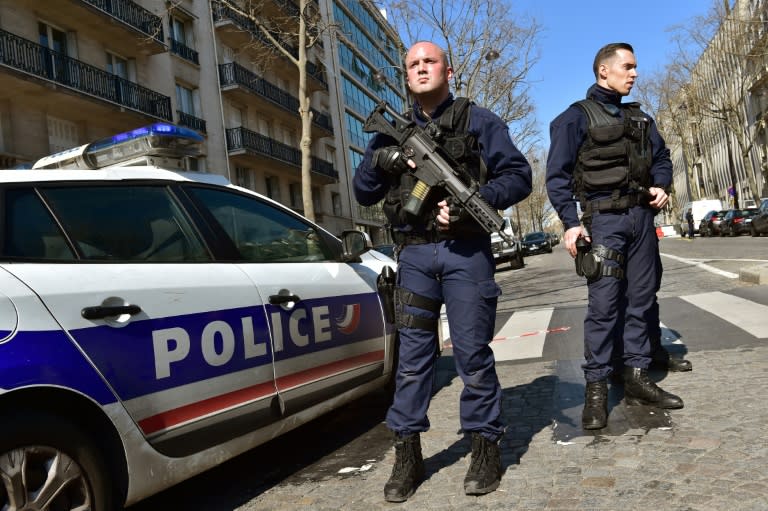 French police secure the scene after a parcel bomb was sent to the IMF offices in Paris, on March 16, 2017