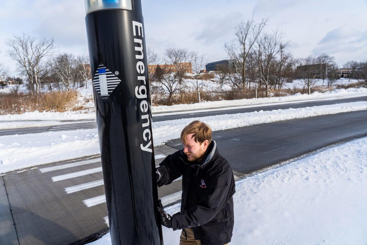 Oakland University Police Department IT manager Kyle Romstad shows how they tend to emergency phones around campus while resetting a phone in a parking lot following a recent firmware update at the campus in Auburn Hills on Tuesday, Jan. 16, 2024.