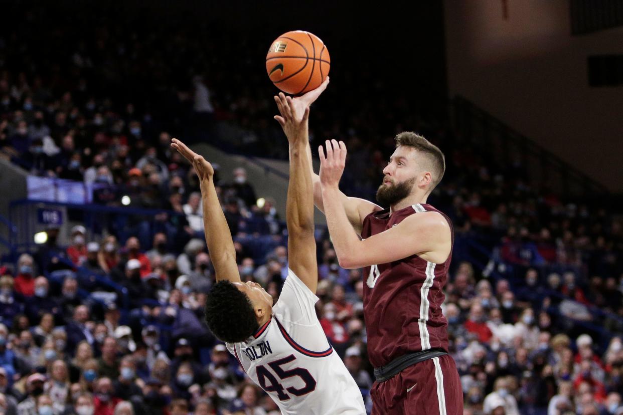 Bellarmine forward Ethan Claycomb, right, shoots over Gonzaga guard Rasir Bolton during the first half of an NCAA college basketball game Friday, Nov. 19, 2021, in Spokane, Wash. (AP Photo/Young Kwak)