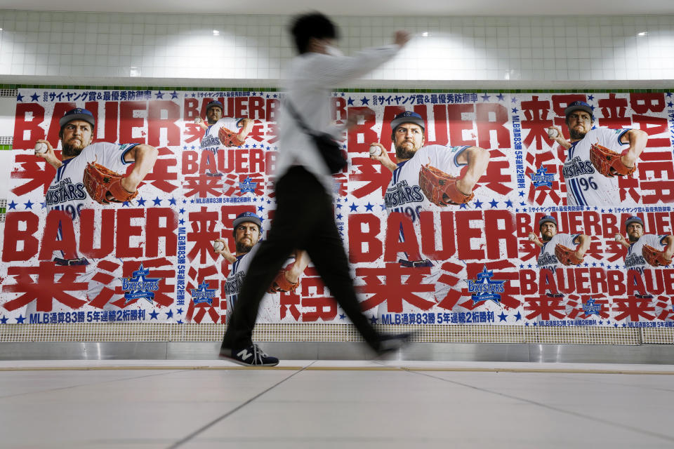 Posters of Trevor Bauer who's pitching for the Yokohama BayStars is placed at the pathway of a subway station on Tuesday, May 2, 2023, in Yokohama near Tokyo. Bauer will pitch his first official game for the Yokohama DeNA BayStars on Wednesday and, to promote the start, a local department store is to unveil a seven-story poster of the former Cy Young winner on the building's facade.(AP Photo/Eugene Hoshiko)