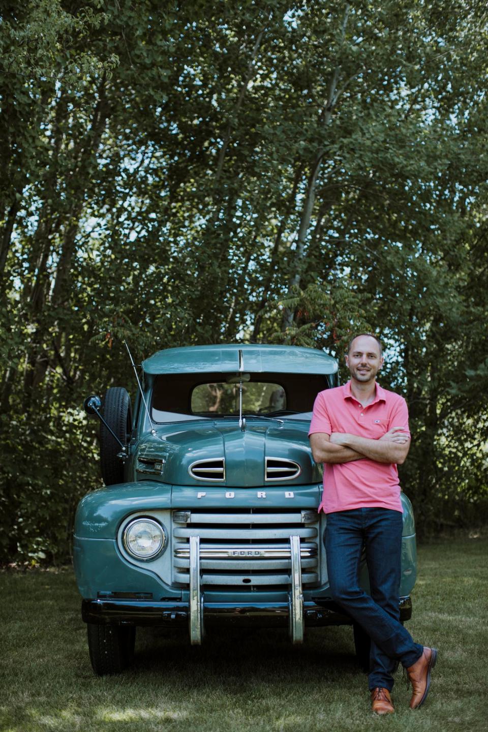 Jonathan Klinger, vice president of car culture at Hagerty, the world's largest insurer of collector vehicles, is pictured at his home in Traverse City, Mich., on July 2020 with his unrestored 1950 Ford F3.