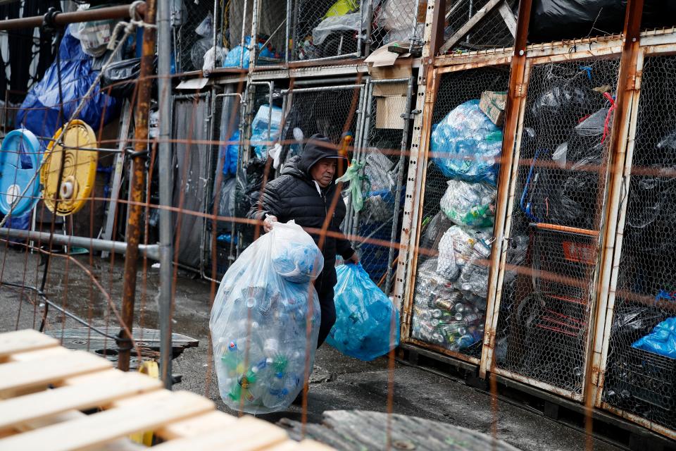 A canner arrives with his haul of plastic bottles at the Sure We Can recycling depot, Thursday, Feb. 27, 2020, in the Bushwick neighborhood of New York. They are called "bottle professionals" by some redemption centers employees who describe them as people who know by heart each recycling and trash pick-up route, who buy from other canners and who take the job seriously.