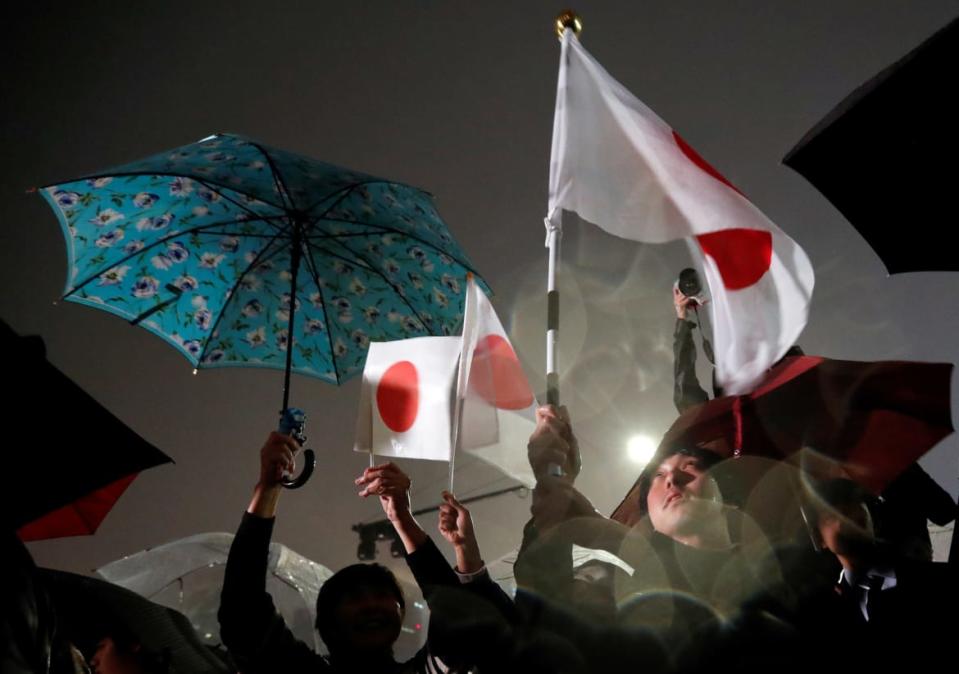 <div class="inline-image__caption"><p>People wave Japanese flags as they gather to celebrate the start of Japan’s new Reiwa imperial era and Emperor Naruhito’s accession to the throne in front of the Imperial Palace in Tokyo, Japan May 1, 2019.</p></div> <div class="inline-image__credit">Issei Kato/Reuters</div>