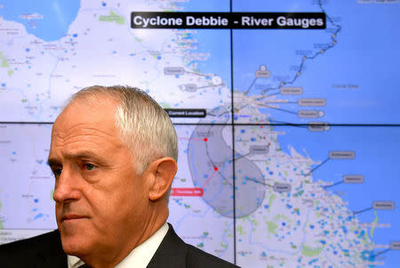 Prime Minister Malcolm Turnbull stands in front of a map showing the path of Cyclone Debbie across the state of Queensland at the Crisis Coordination Centre in Canberra, Australia, March 29, 2017. AAP/Mick Tsikas/via REUTERS