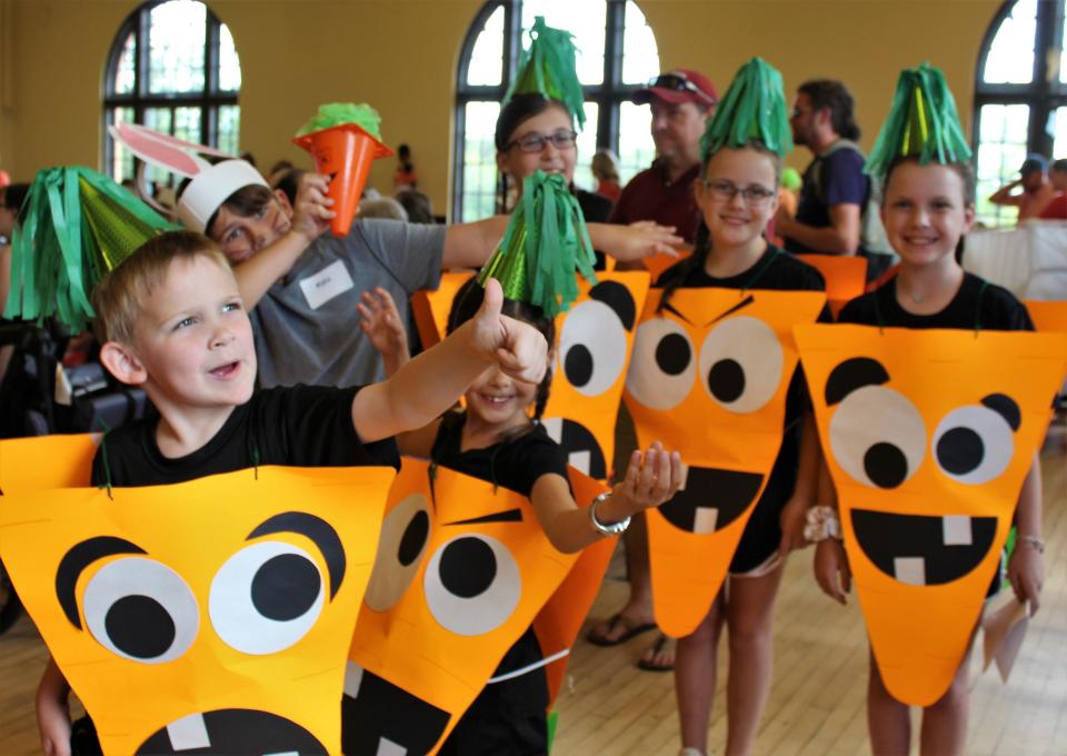 That's a bunch of Creepy Carrots! posing for a mom's cellphone photo at the Children's Art & Literacy Festival costume contest at the Elks Center in 2019, when Peter Brown was honored.