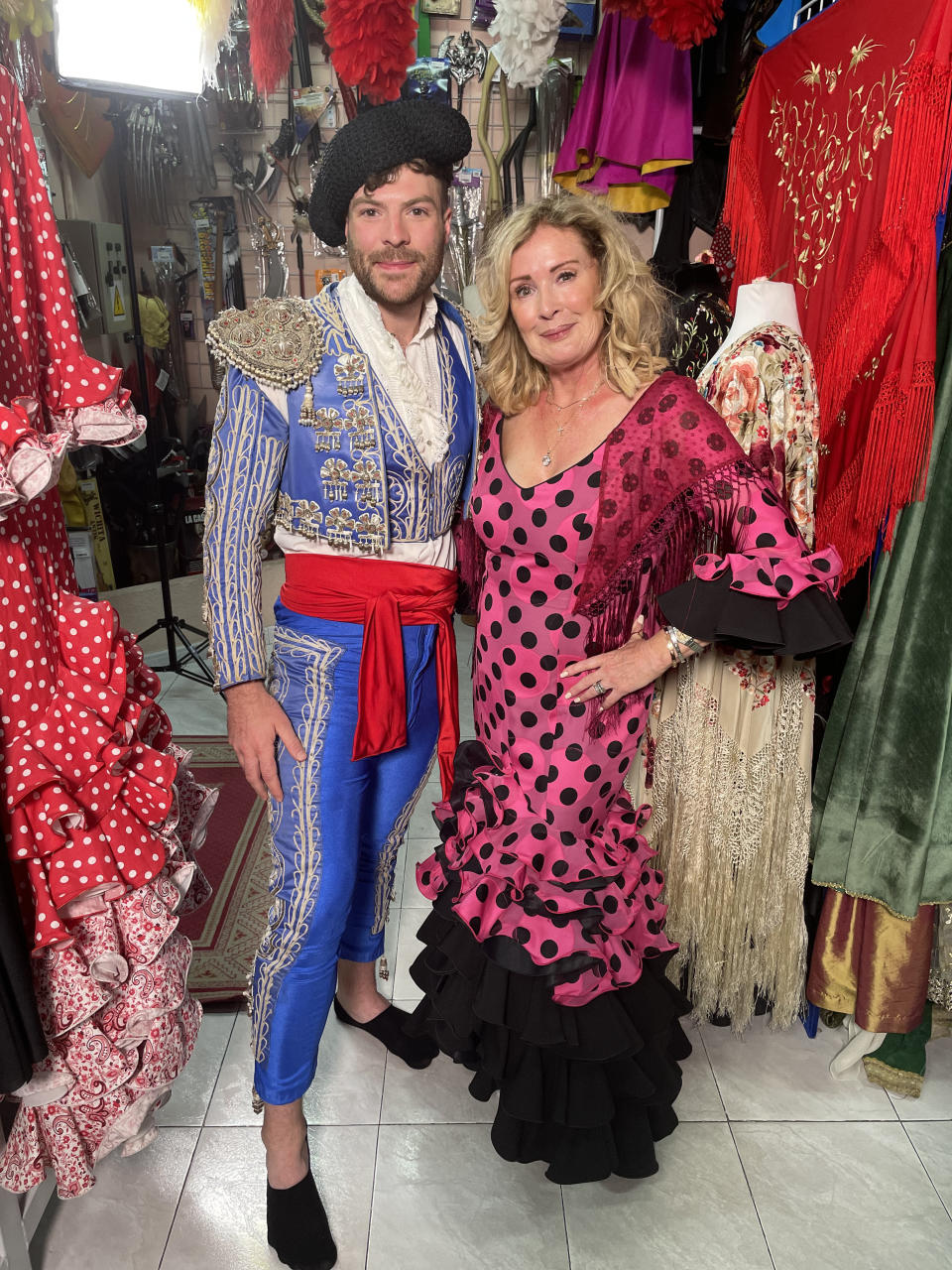 This image and the information contained herein is strictly embargoed until 00.01 Tuesday 19th October 2021

From Lifted Entertainment North

Beverley & Jordan: Destination Wedding: Ep2 on ITV and ITV Hub.

Pictured: Jordan North and Beverley Callard try traditional Spanish dress in Madrid.

This photograph is (C) ITV Plc and can only be reproduced for editorial purposes directly in connection with the programme or event mentioned above, or ITV plc. Once made available by ITV plc Picture Desk, this photograph can be reproduced once only up until the transmission [TX] date and no reproduction fee will be charged. Any subsequent usage may incur a fee. This photograph must not be manipulated [excluding basic cropping] in a manner which alters the visual appearance of the person photographed deemed detrimental or inappropriate by ITV plc Picture Desk.  This photograph must not be syndicated to any other company, publication or website, or permanently archived, without the express written permission of ITV Picture Desk. Full Terms and conditions are available on the website www.itv.com/presscentre/itvpictures/terms

For further information please contact:
james.hilder@itv.com / 0207 157 3052