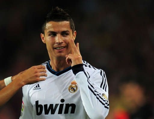 Real Madrid's Portuguese forward Cristiano Ronaldo celebrates after scoring a goal during the Spanish League Clasico football match FC Barcelona vs Real Madrid CF at the Camp Nou stadium in Barcelona. The match ended in a 2-2 draw