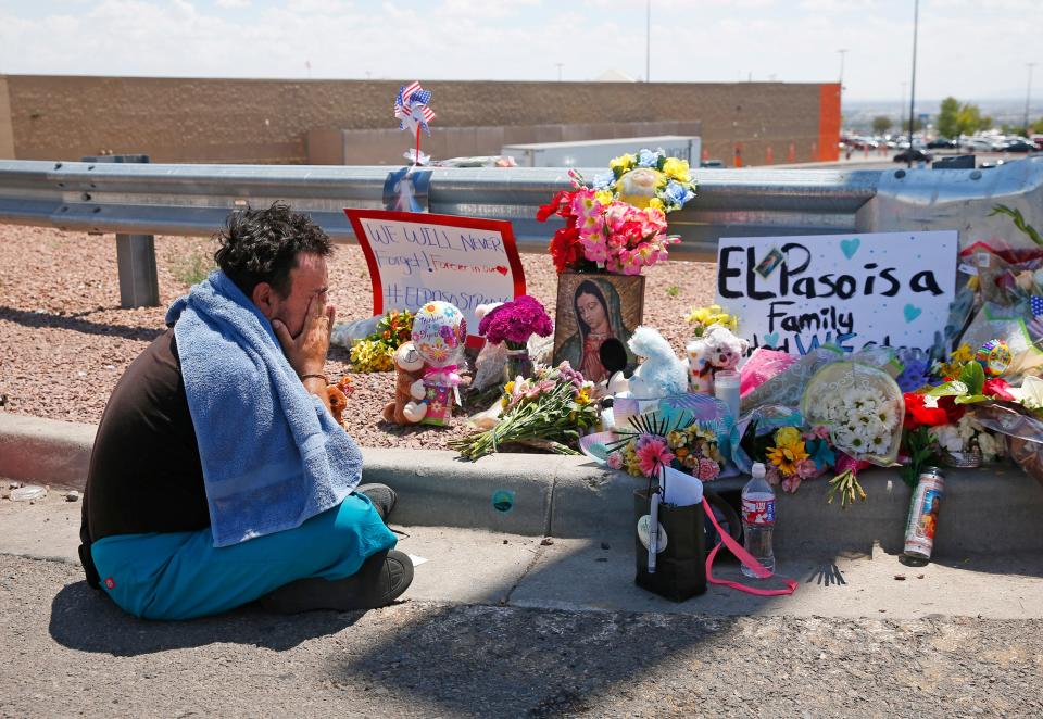 Felipe Avila mourns outside a Walmart in El Paso after a mass shooting on Aug. 4, 2019.