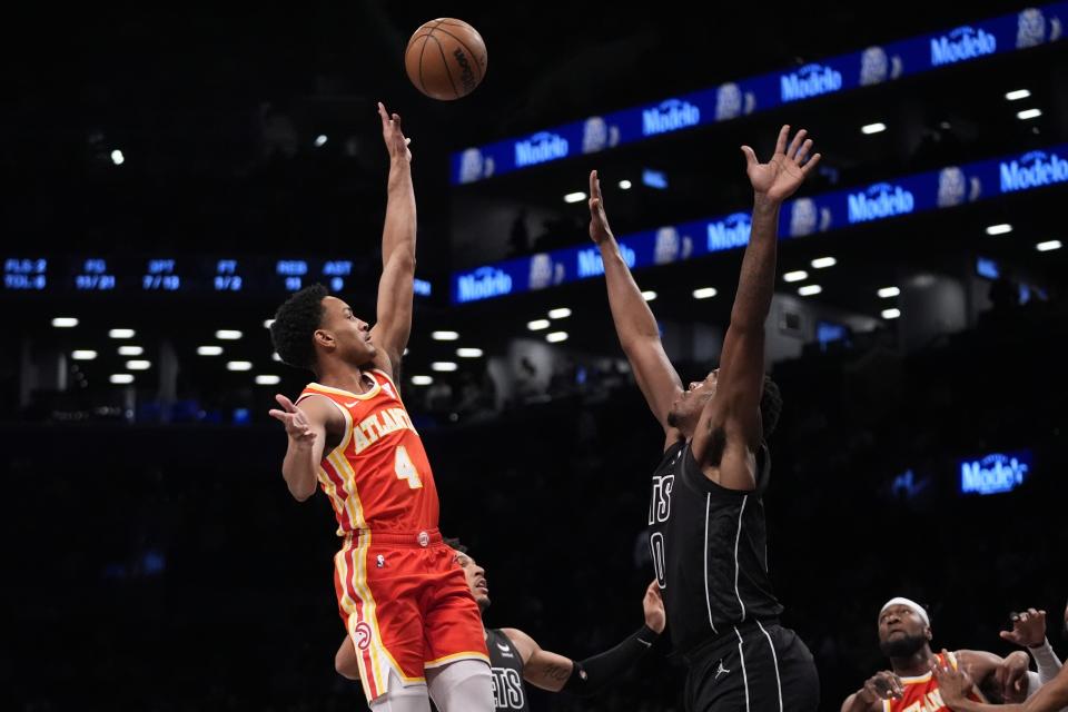 Atlanta Hawks' Kobe Bufkin (4) shoots over Brooklyn Nets' Day'Ron Sharpe (20) during the first half of an NBA basketball game Thursday, Feb. 29, 2024, in New York. (AP Photo/Frank Franklin II)