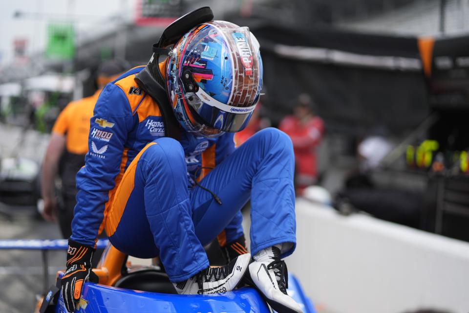 Kyle Larson climbs out of his car during a practice session for the Indianapolis 500 auto race at Indianapolis Motor Speedway, Thursday, May 16, 2024, in Indianapolis. (AP Photo/Darron Cummings)