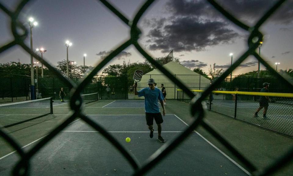 A pickleball player goes after a ball in the pickleball courts at Tropical Park.