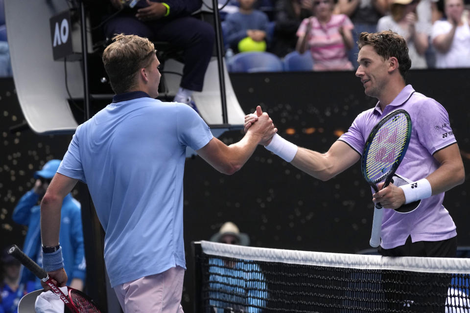 Jenson Brooksby, left, of the U.S. is congratulated by Casper Ruud of Norway following their second round match at the Australian Open tennis championship in Melbourne, Australia, Thursday, Jan. 19, 2023. (AP Photo/Dita Alangkara)