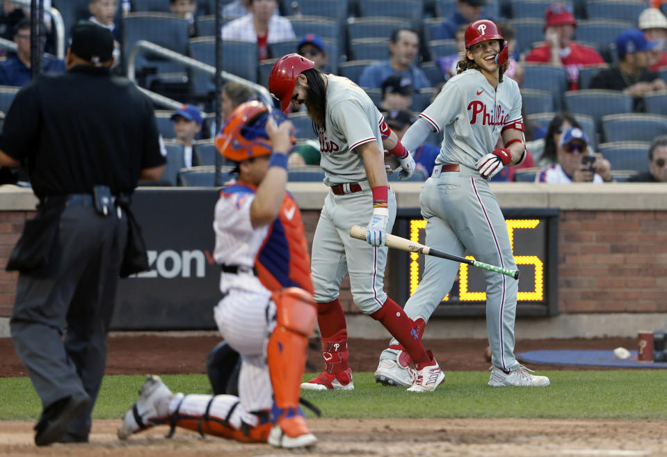 Phillies' Alec Bohm, right, celebrates with teammate Brandon Marsh, second from right, after hitting a home run against the New York Mets during the sixth inning of a baseball game, Sunday, Oct. 1, 2023, in New York. (AP Photo/Noah K. Murray)