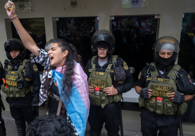 Police guard the entrance of Peru's Ministry of Health during a protest staged by LGBTQ groups against a new government decree listing transsexualism as a "mental disorder" (Cris BOURONCLE)