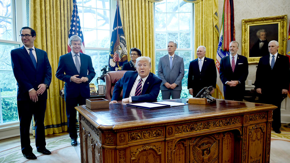 President Donald Trump prepares to sign the Paycheck Protection Program and Health Care Enhancement Act in the Oval Office of the White House in Washington, DC, on April 24, 2020.  (Olivier Douliery/AFP via Getty Images)