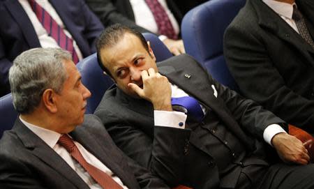 Turkey's Deputy Prime Minister Bulent Arinc (L) and European Affairs Minister Egemen Bagis chat as they wait for the start of the speech of Prime Minister Tayyip Erdogan during a meeting at ruling Ak Party (AKP) headquarters in Ankara December 25, 2013. REUTERS/Umit Bektas