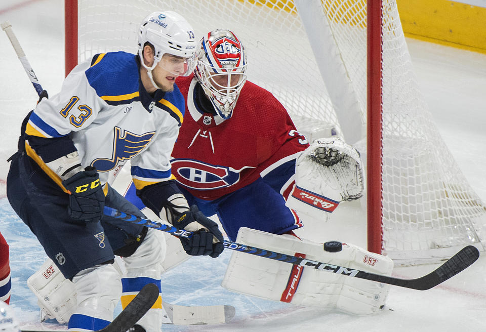 St. Louis Blues' Alexey Toropchenko (13) moves in on Montreal Canadiens goaltender Jake Allen during the first period of an NHL hockey game Saturday, Jan. 7, 2023, in Montreal. (Graham Hughes/The Canadian Press via AP)