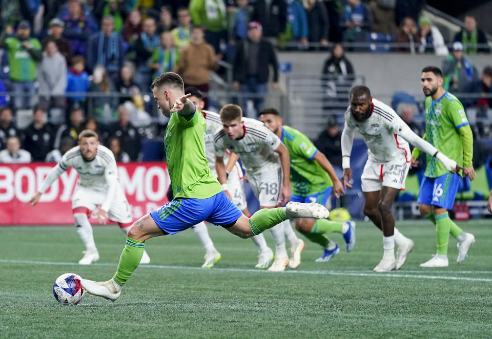 Seattle Sounders midfielder Albert Rusnák, front, converts a penalty kick for a goal against FC Dallas during the first half of an MLS playoff soccer match Monday, Oct. 30, 2023, in Seattle. (AP Photo/Lindsey Wasson)