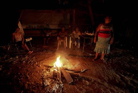 People sit outside their houses to prevent looters from entering their homes in Acapulco September 17, 2013. REUTERS/Jacobo Garcia