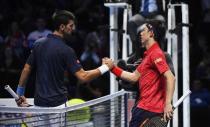 Britain Tennis - Barclays ATP World Tour Finals - O2 Arena, London - 19/11/16 Serbia's Novak Djokovic and Japan's Kei Nishikori after their semi final math Reuters / Toby Melville