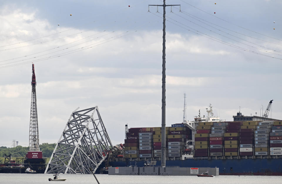 Remnants of the collapsed Francis Scott Key Bridge and the cargo ship Dali are seen, Sunday, May 12, 2024, in Baltimore. For safety reasons, officials postponed a controlled demolition, which was planned for Sunday, to break down the largest remaining span of the collapsed bridge. The bridge came crashing down under the impact of the massive container ship on March 26. (AP Photo/Steve Ruark)