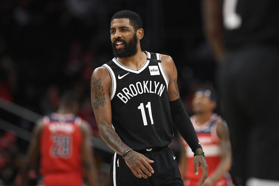 Brooklyn Nets guard Kyrie Irving (11) reacts during the first half of an NBA basketball game against the Washington Wizards, Saturday, Feb. 1, 2020, in Washington. (AP Photo/Nick Wass)